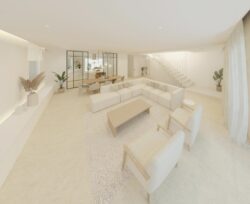 Salón-comedor de vivienda contemporánea con distribución abierta, mobiliario claro y escalera interior